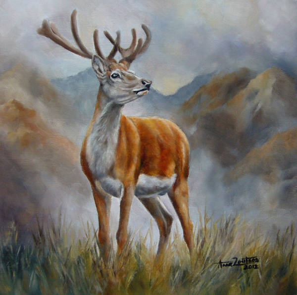 A stag standing against a mountainous landscape