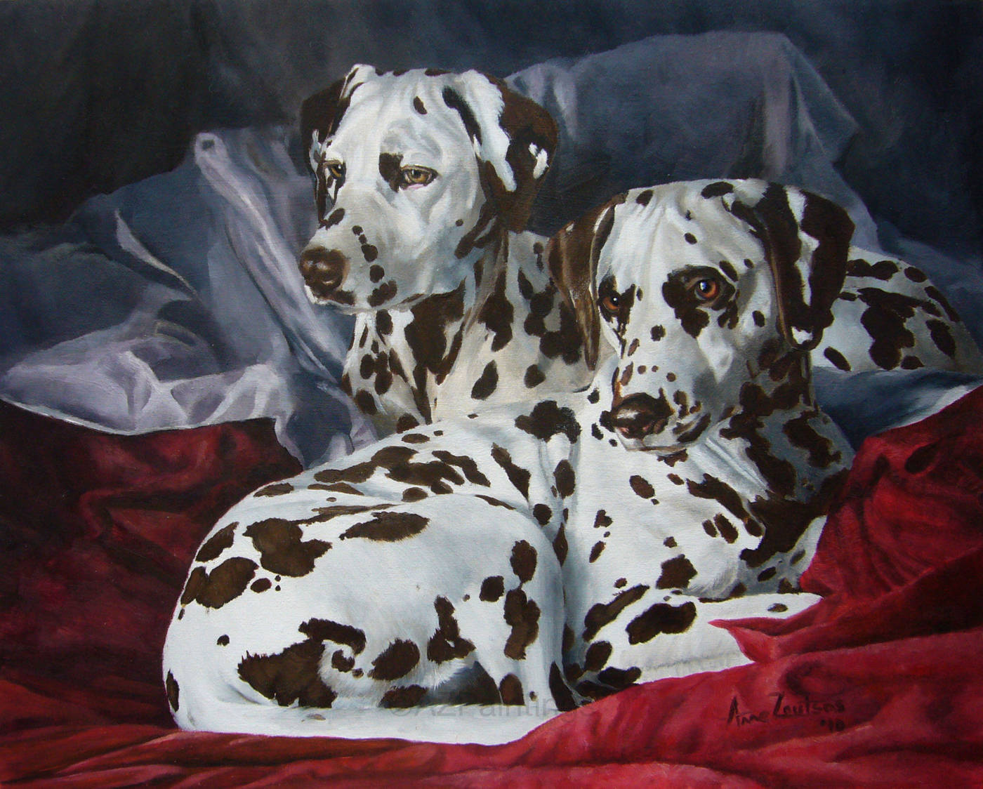 A pair of liver-spotted Dalmatians lying on richly coloured bedding